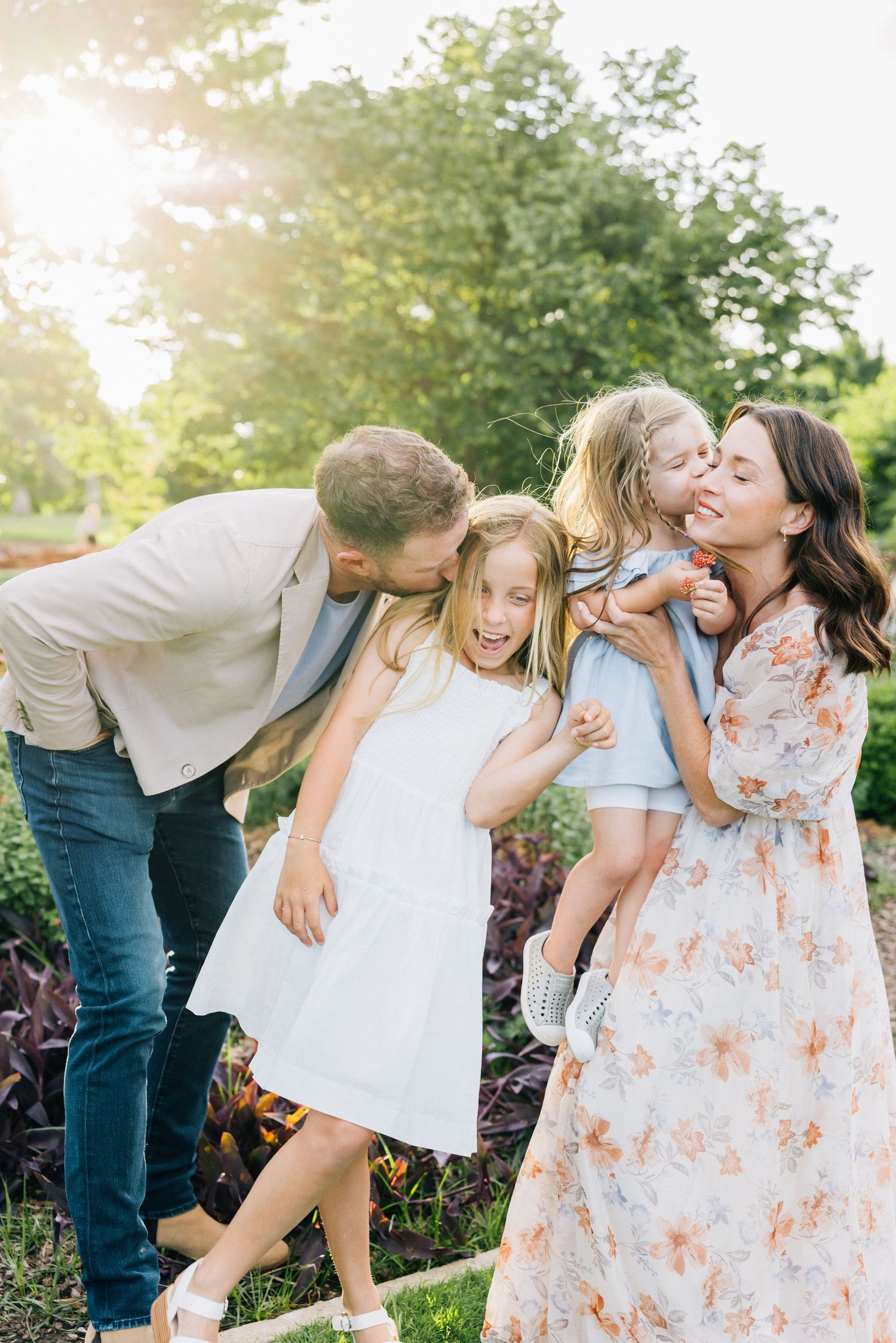 A sweet series of family photos captured in a garden setting during golden hour showing tender moments and playful interactions.