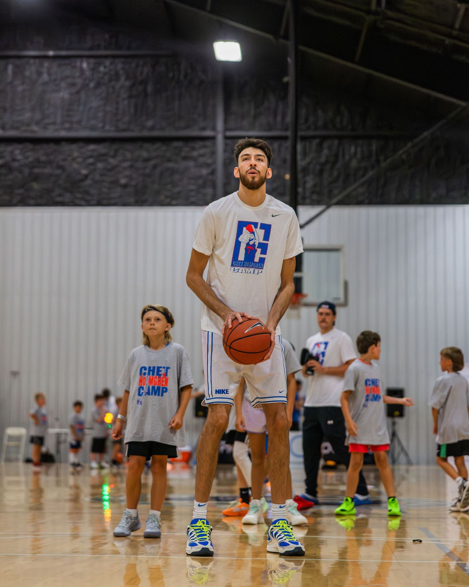 Chet Holmgren plays Gotcha with a group of youth campers.