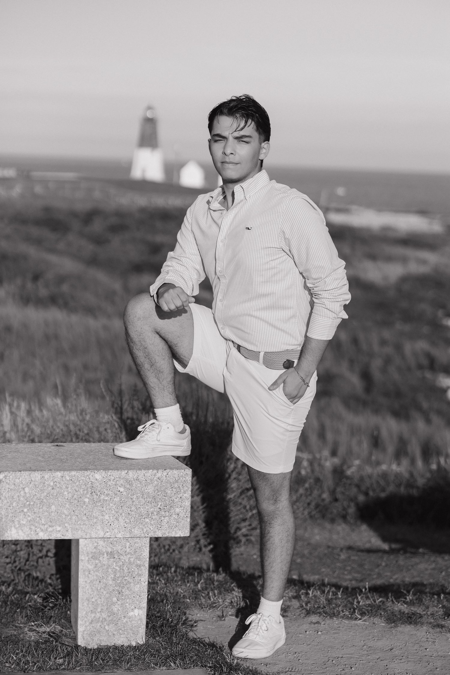 Black and white photo series showing someone in white clothing posing with their foot on a concrete block outdoors.