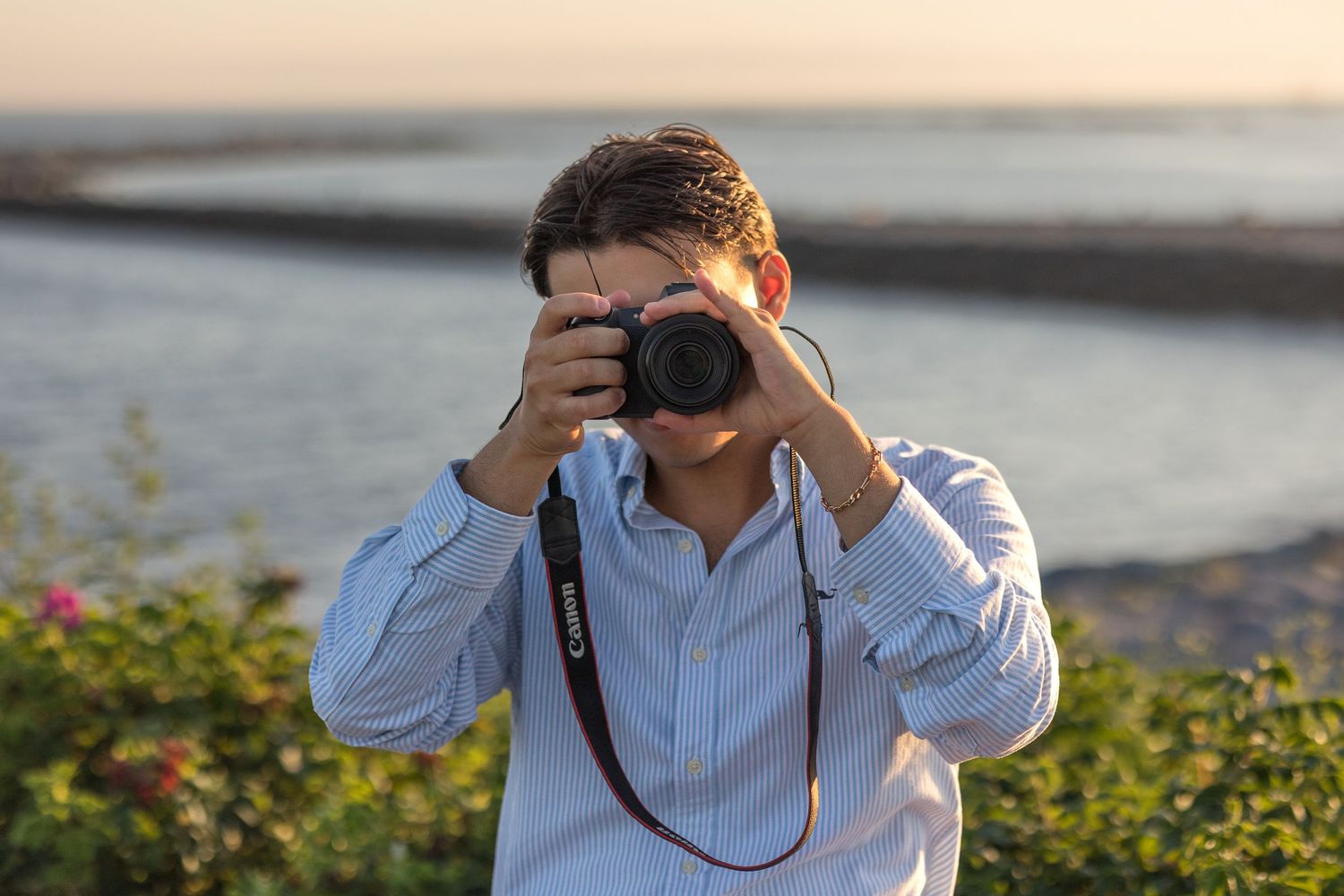 A series of photos showing someone in a white shirt using binoculars outdoors during sunset.