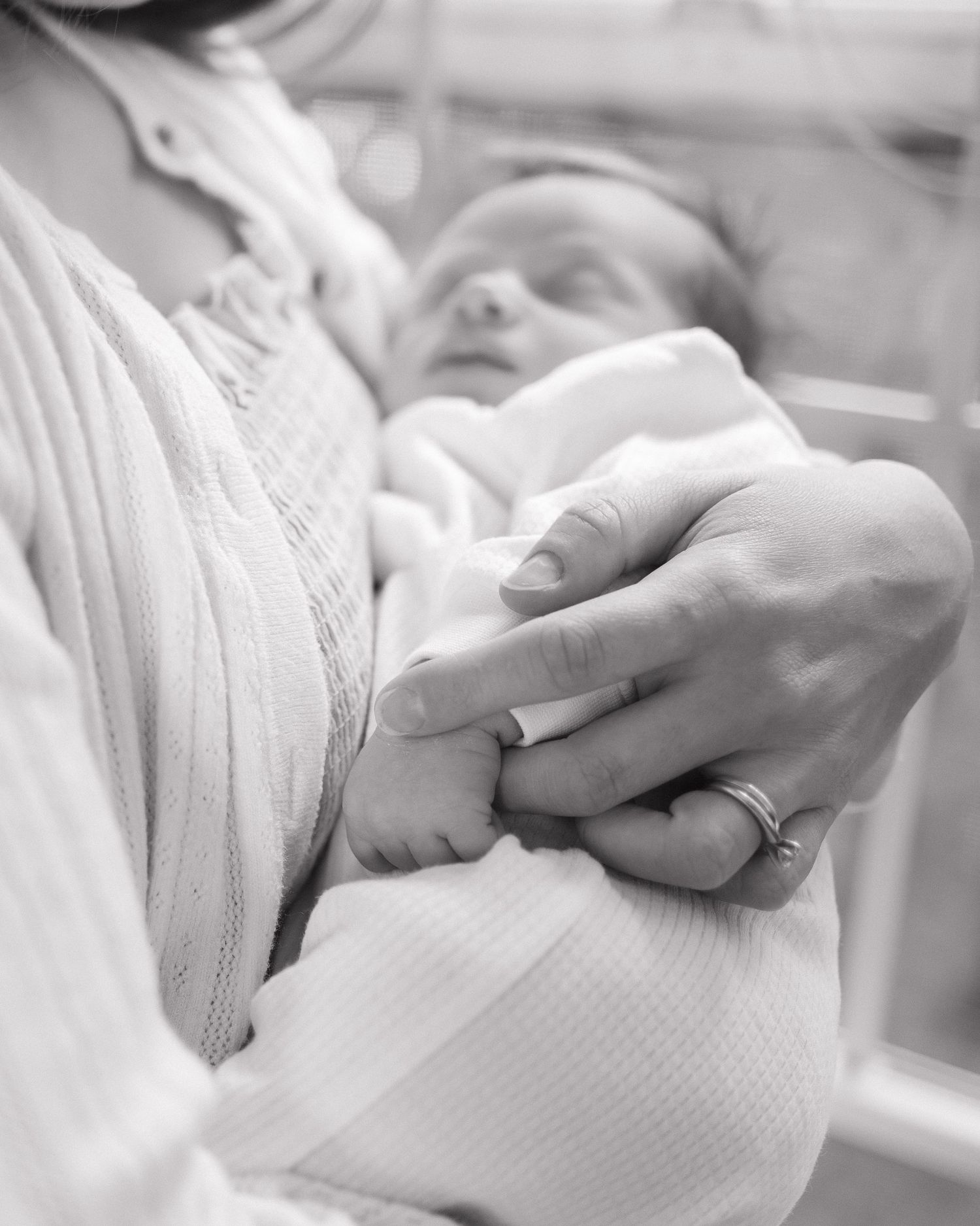 Close-up details of white textured fabric with gentle hands.