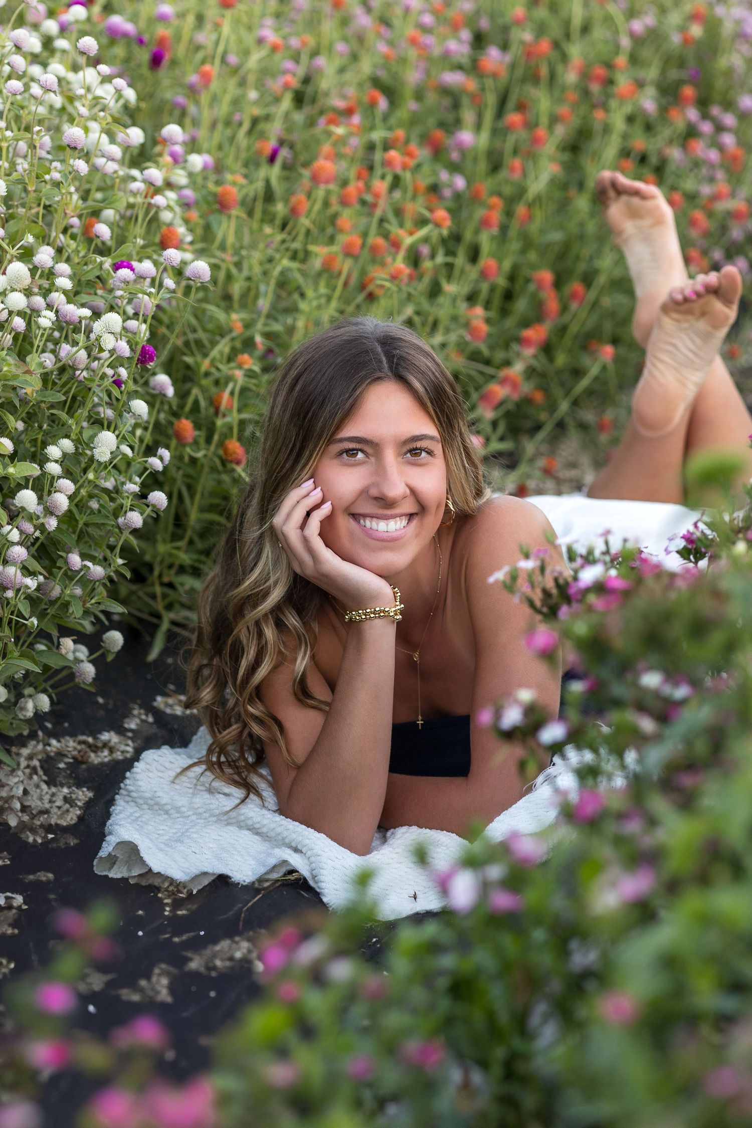 A series of outdoor portrait photos among colorful wildflowers and greenery in a garden setting.