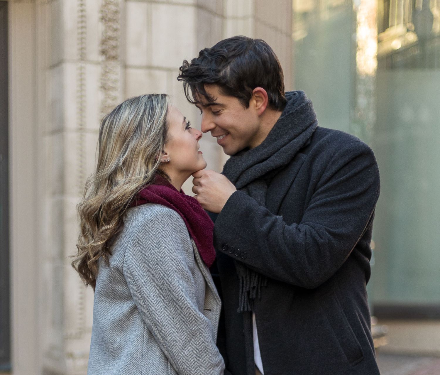 An intimate moment shared between a couple on a city street.
