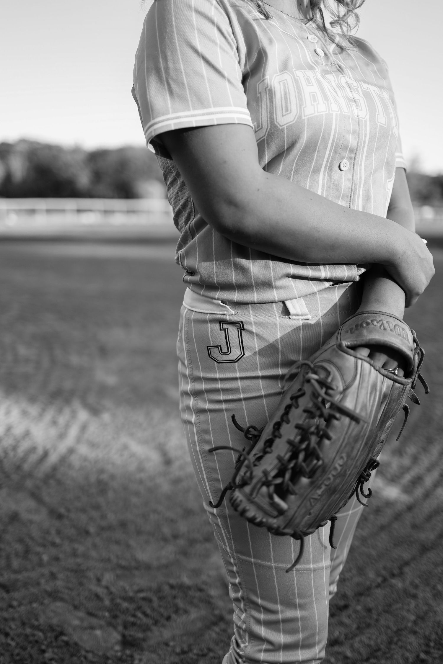 A series of black and white photos showing a baseball player in pinstripe uniform holding a glove from different angles.