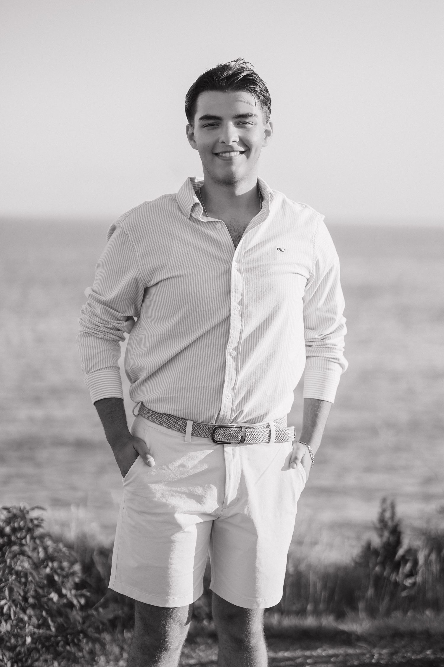 A series of black and white photos showing a person in white clothing standing outdoors against a natural landscape.