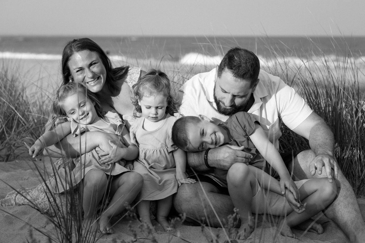 A relaxed family moment together in the beach dunes.