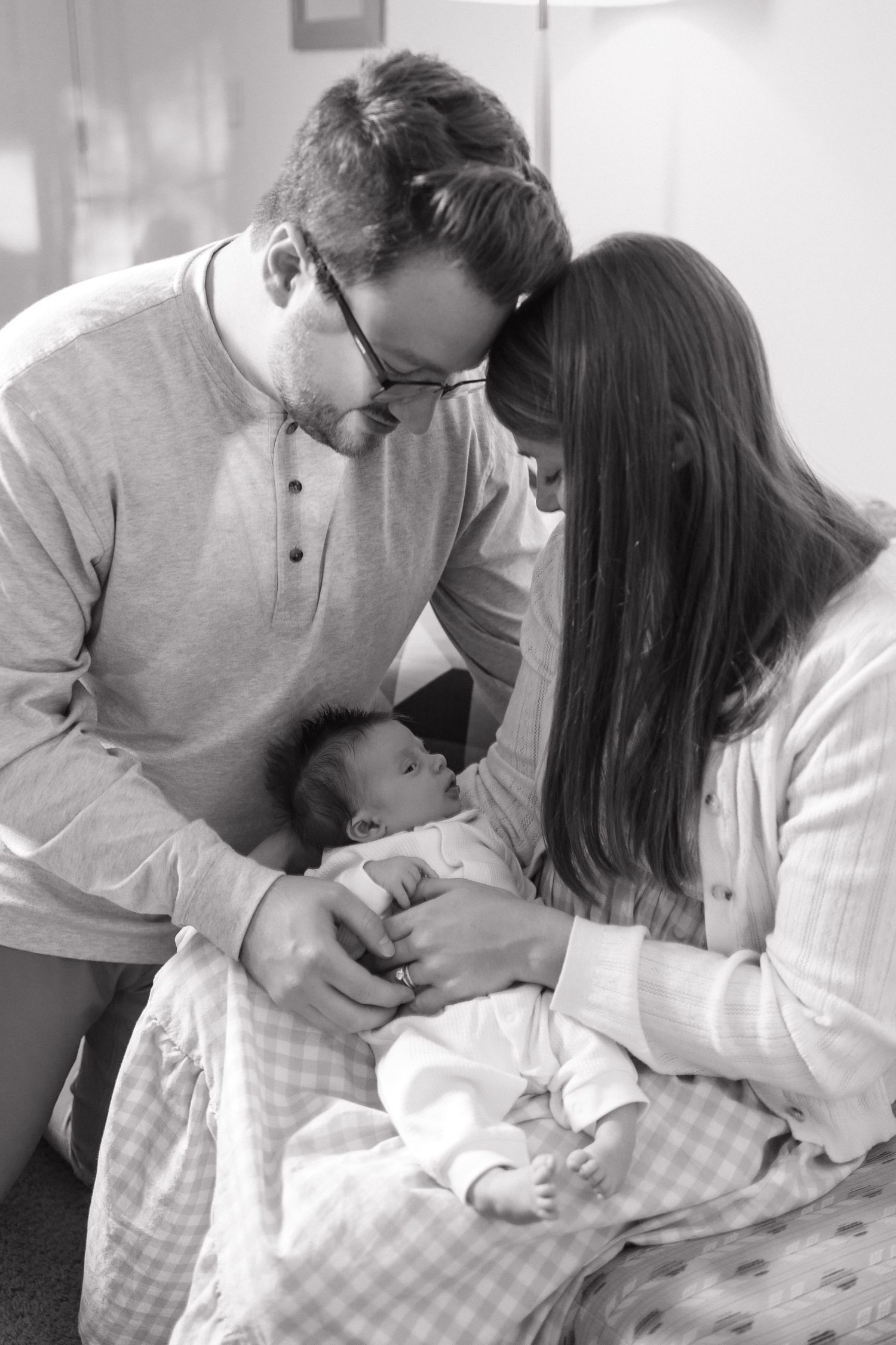 A series of intimate black and white photos showing a tender moment between two people in casual attire.
