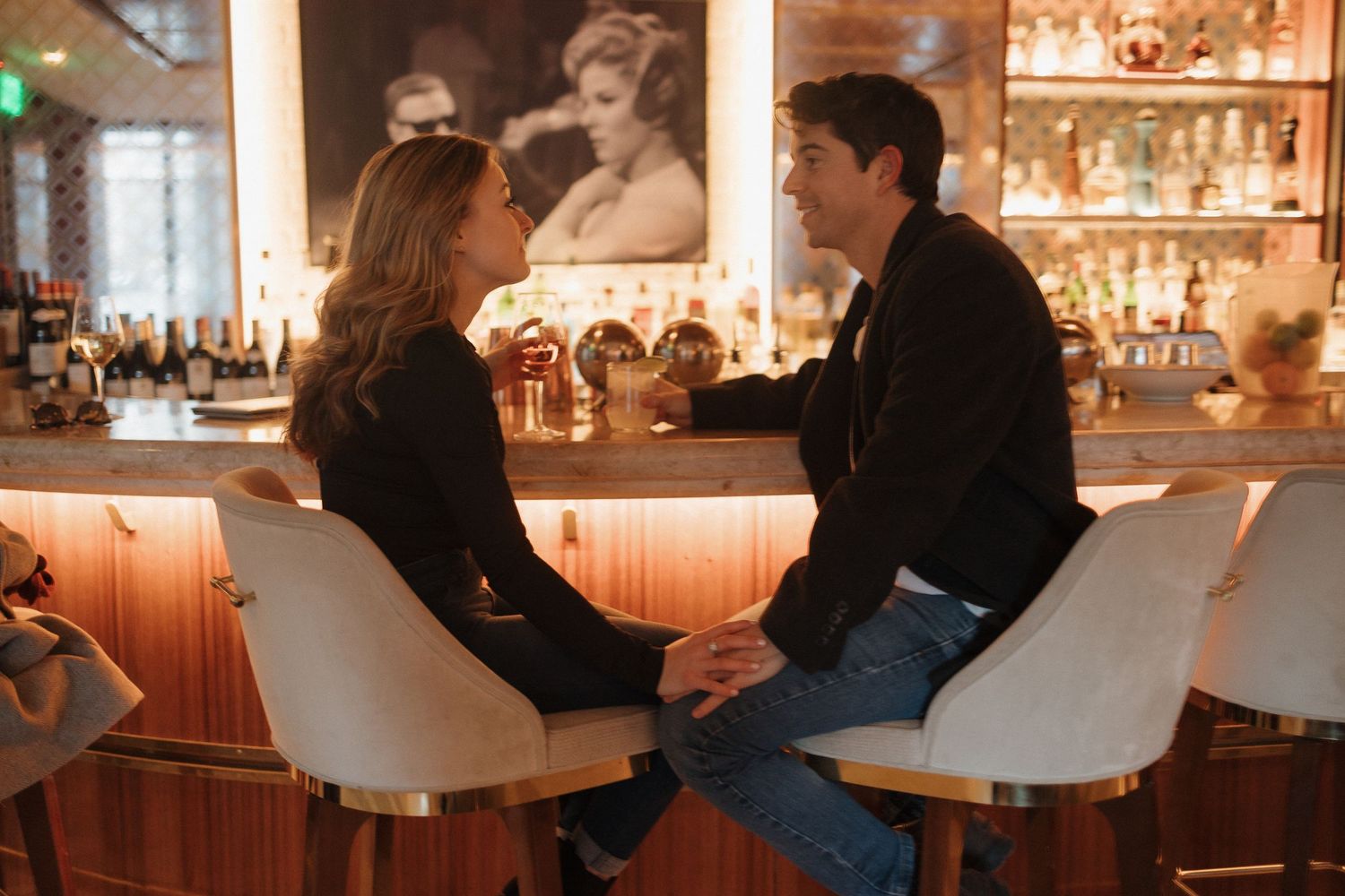 A cozy date night scene at a warmly lit bar.