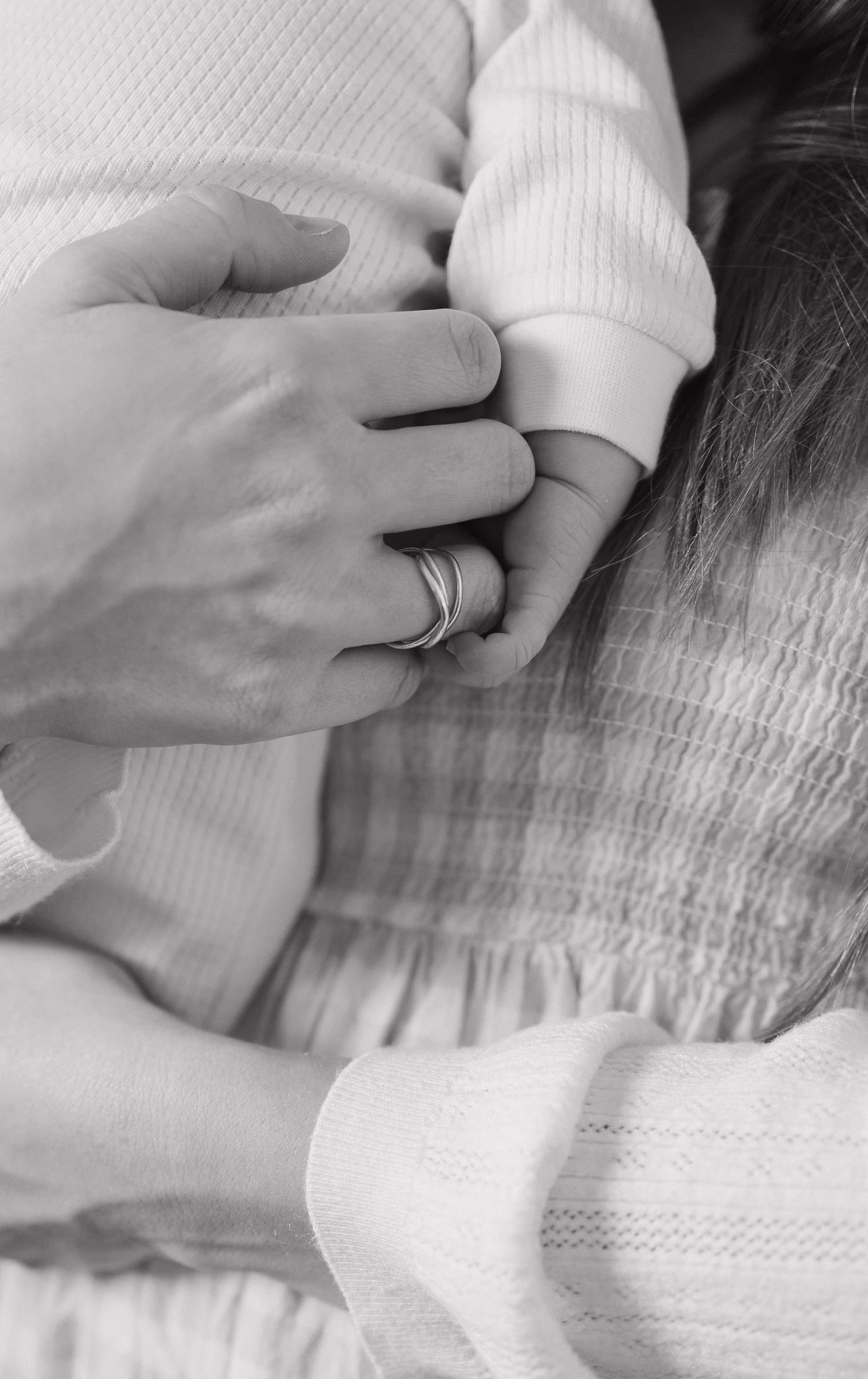 A sequence of black and white close-up photos showing hands gently massaging a textured surface.