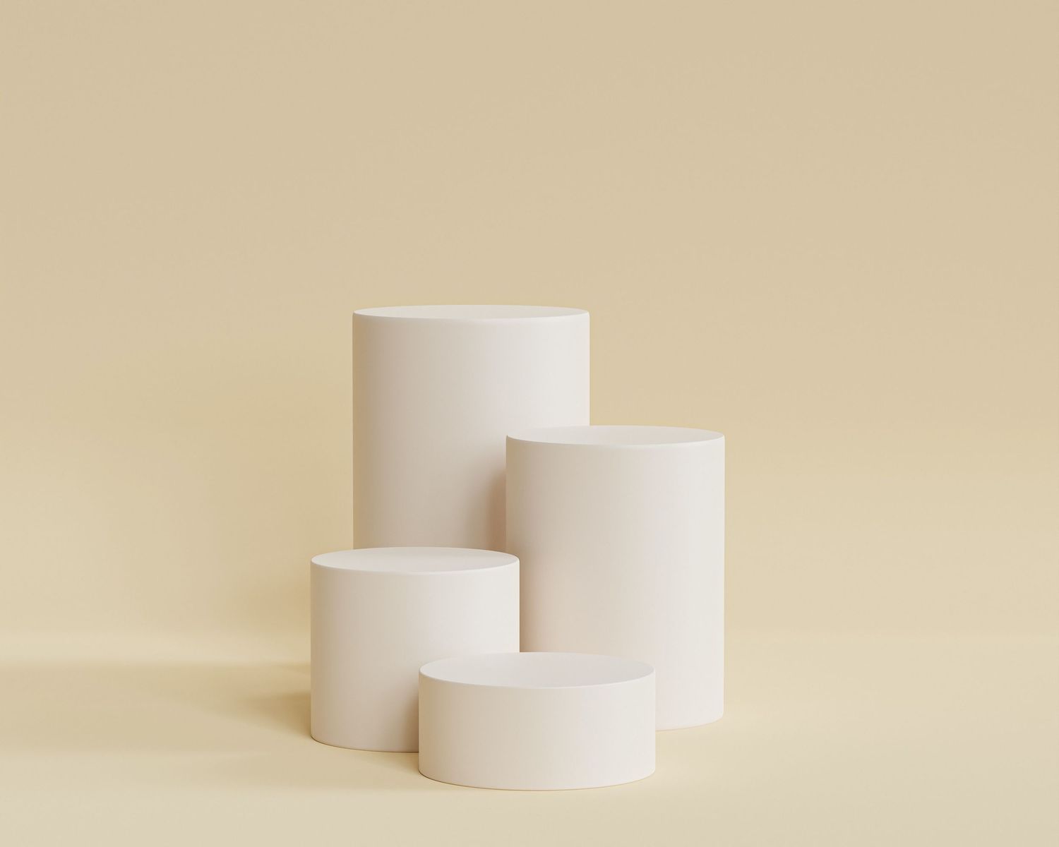Minimalist product display with white cylindrical pedestals on beige background.