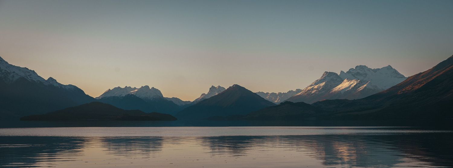 A panoramic series of mountain landscapes with reflective lakes and snow-capped peaks at sunset.