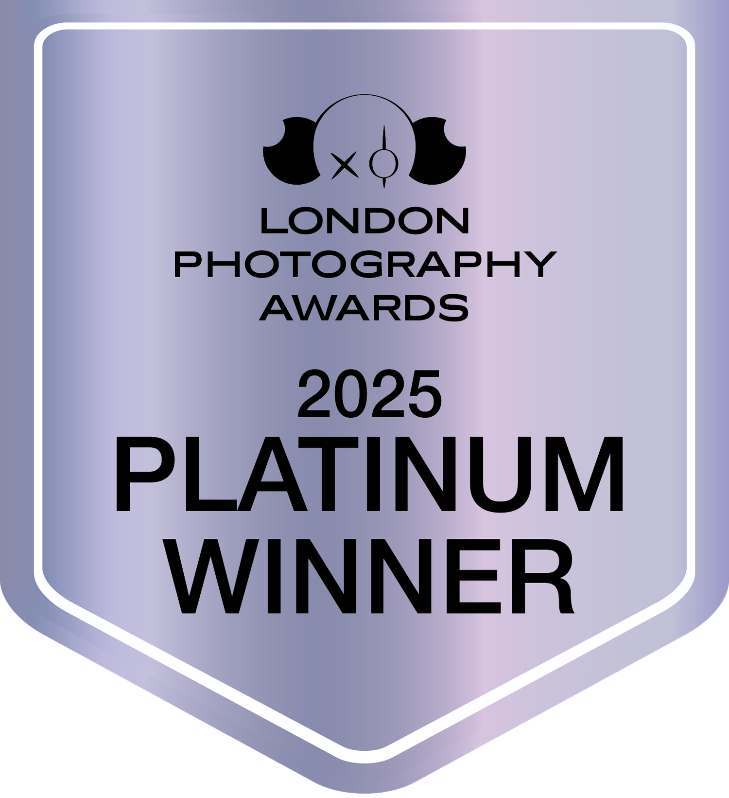 A silver shield-shaped badge with the London Photography Awards 2025 Platinum Winner logo in black text.