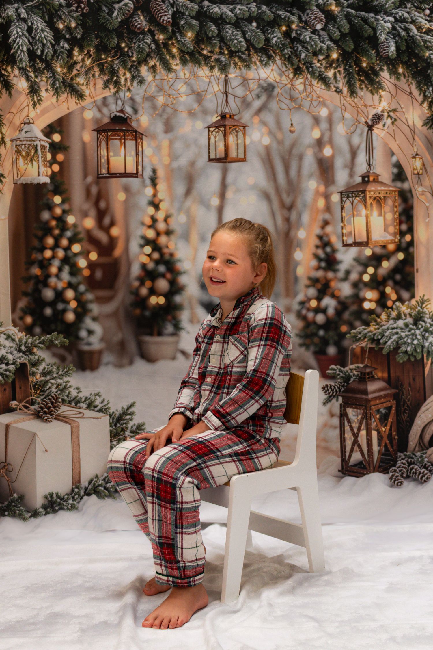 Festive holiday scene with lanterns and decorations featuring a cozy plaid pajama set in a snowy winter wonderland setting.