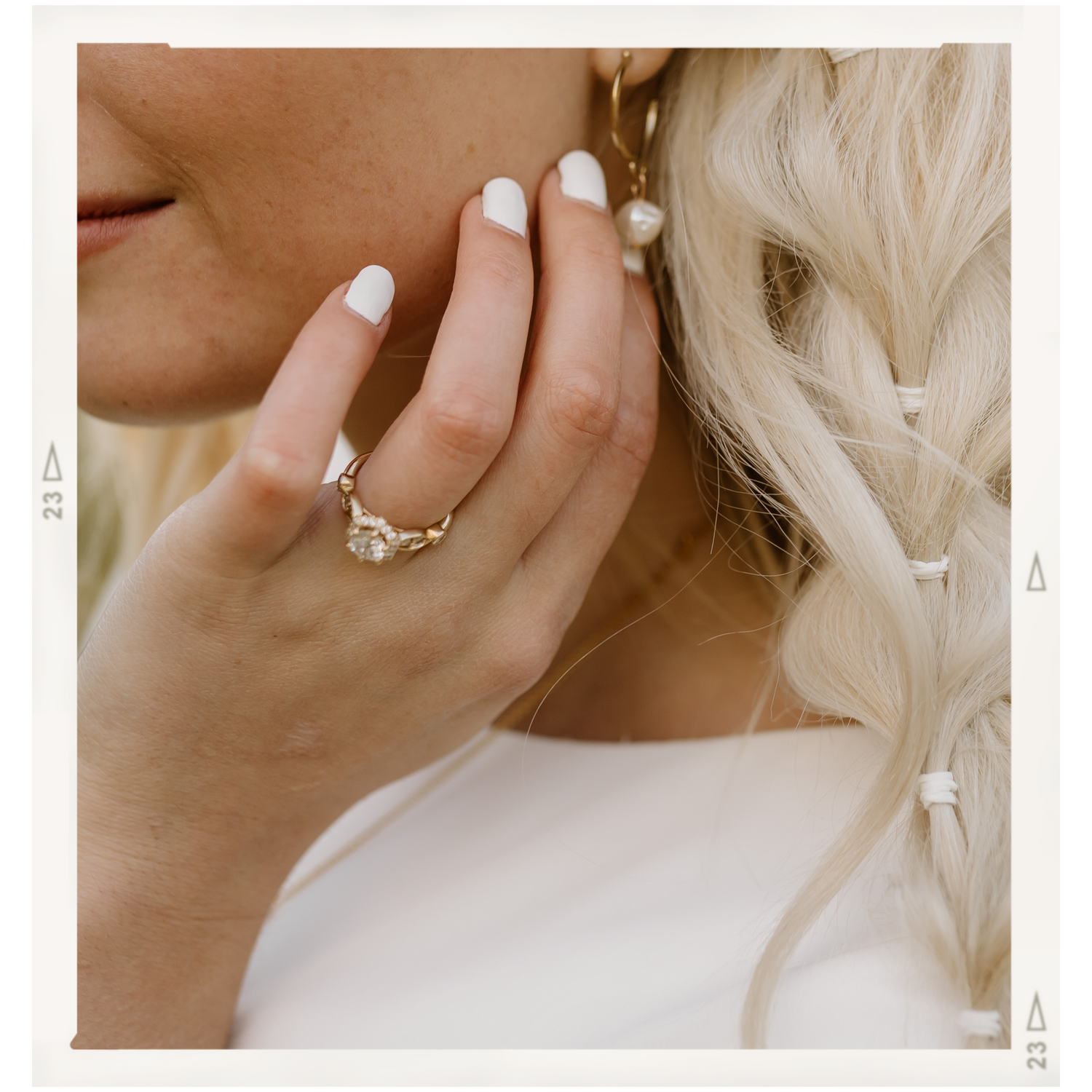 Close-up of a delicate vintage-style wedding ring with pearl details.
