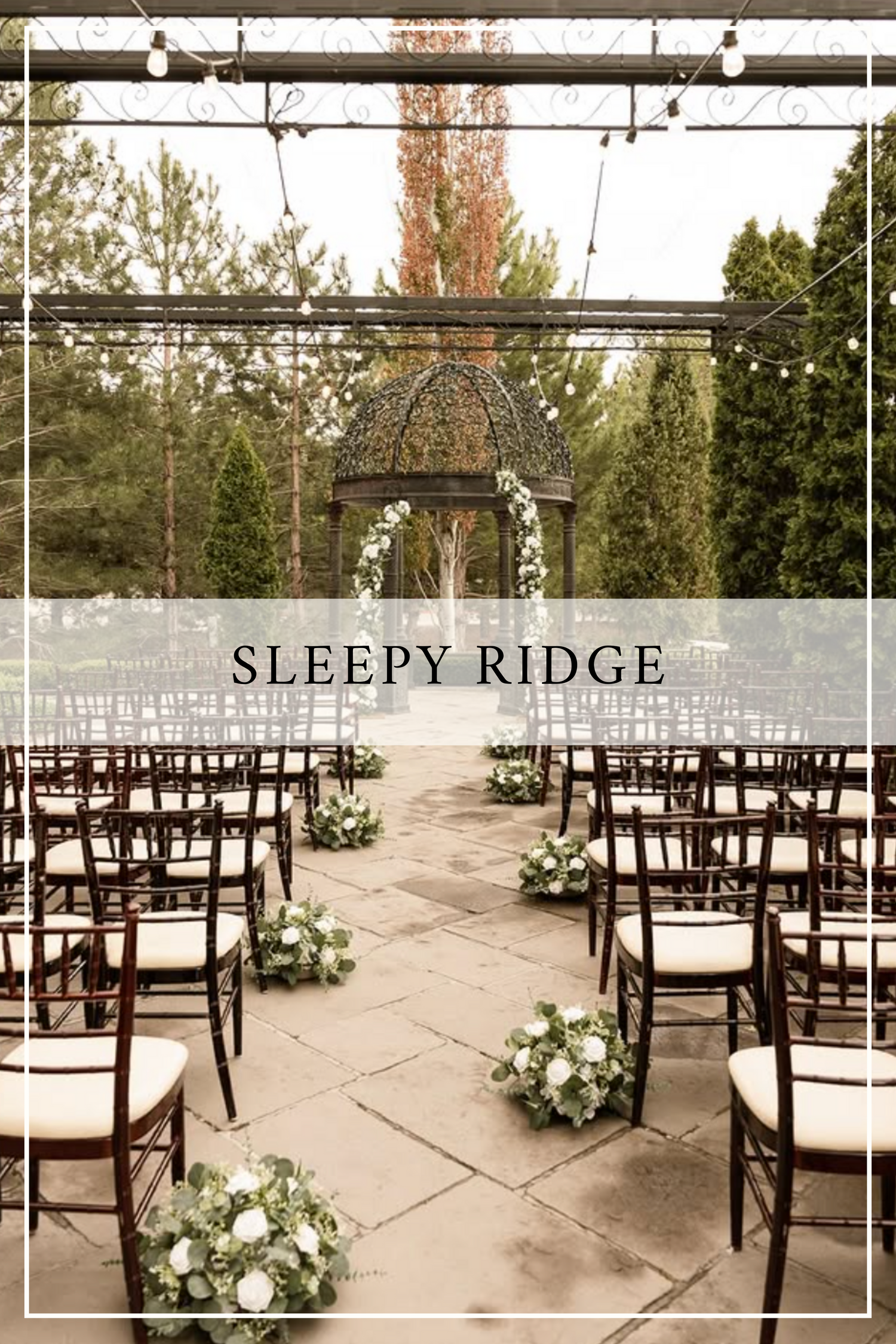 Outdoor wedding ceremony setup at Sleepy Ridge venue with wooden chairs, string lights and floral aisle decorations.