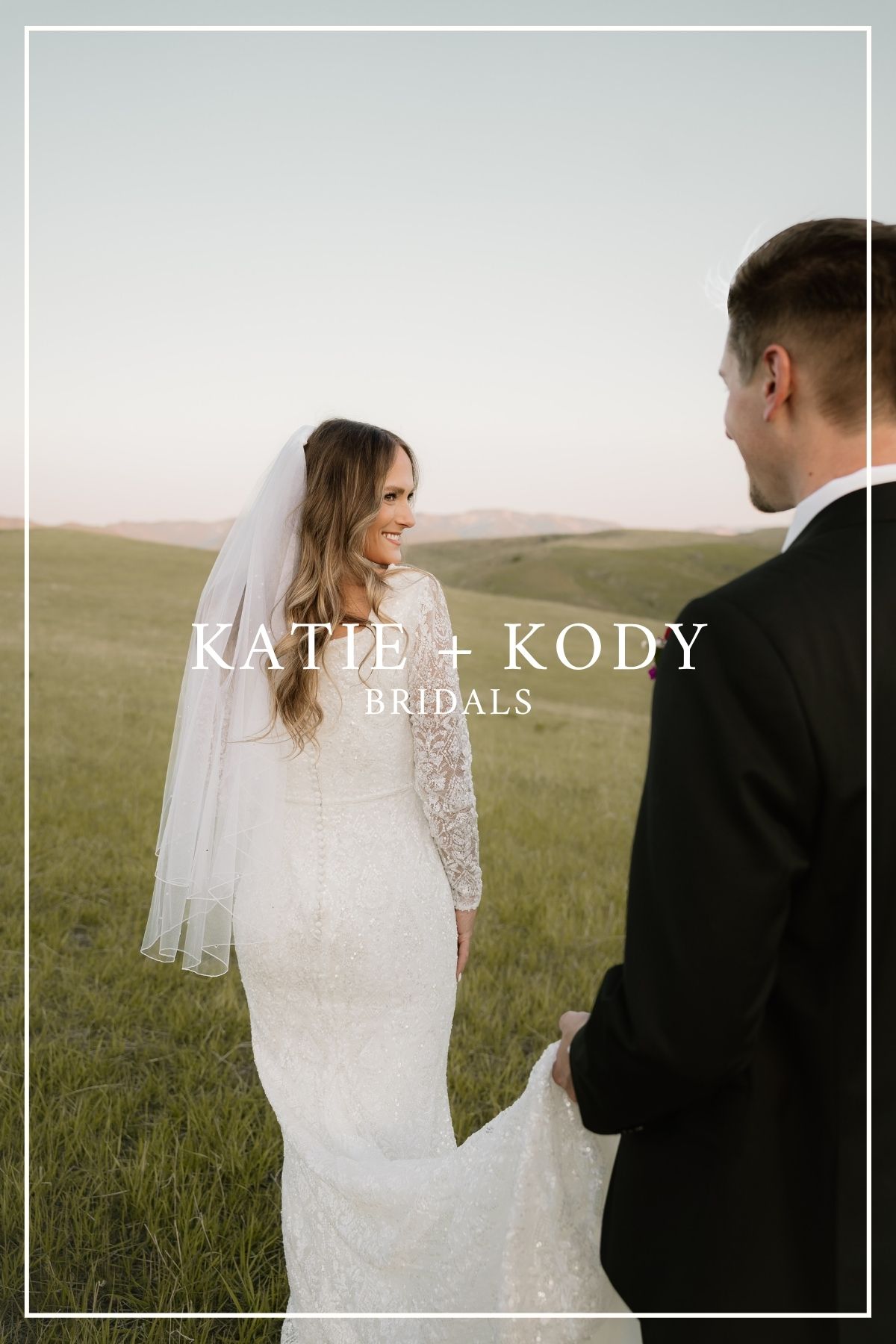 Bride in lace-sleeved wedding dress and groom share a romantic moment in a sunlit meadow during golden hour.