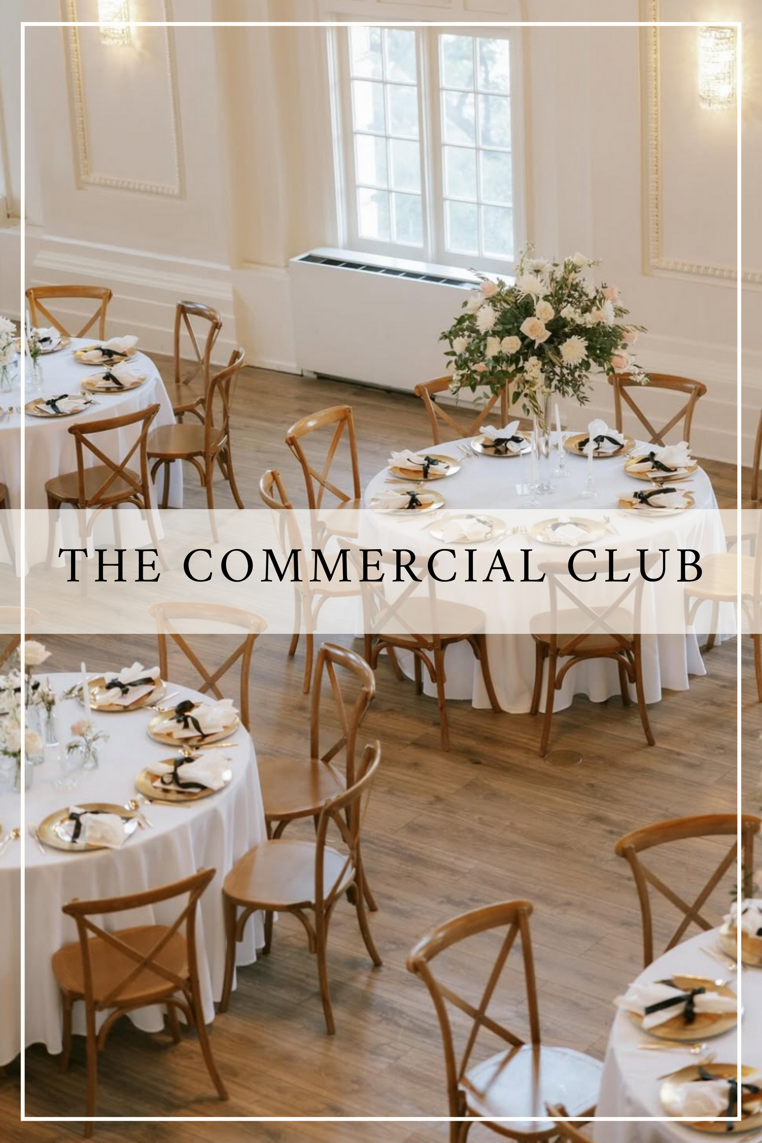 Elegant event space with round white tables, wooden crossback chairs and floral centerpiece at The Commercial Club.