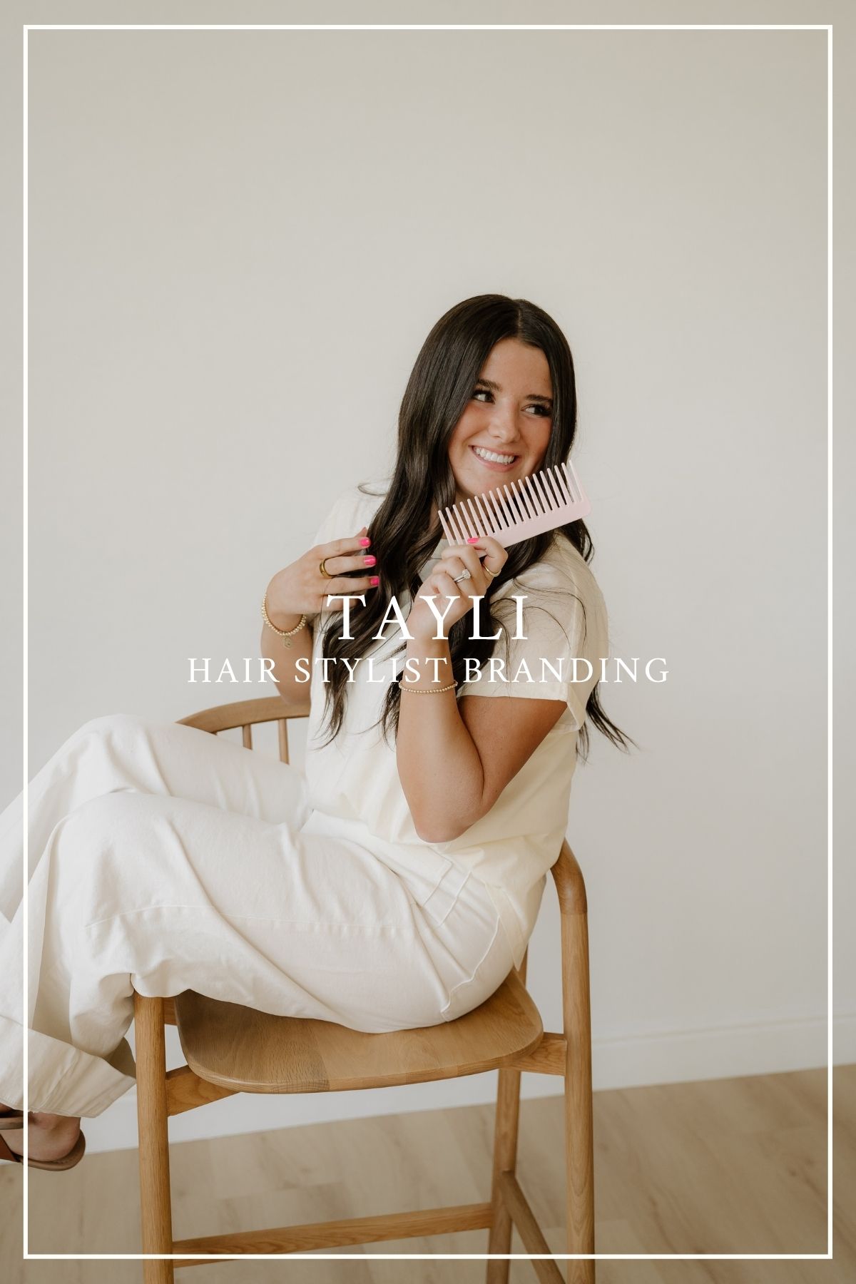 Professional branding photo featuring a white-dressed person sitting casually on a wooden chair against a neutral backdrop.