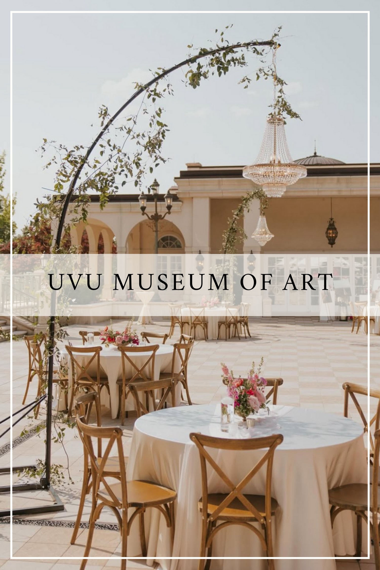 Elegant outdoor event setup at UVU Museum of Art with white round tables, wooden chairs, and floral archway decor.