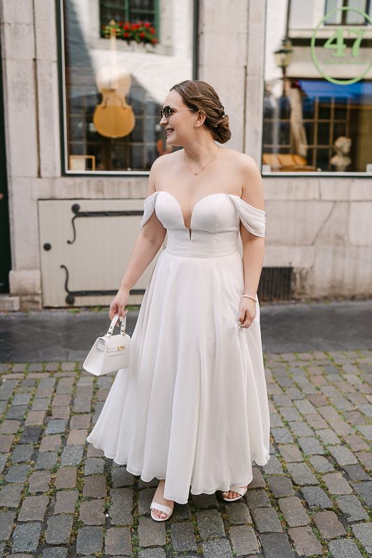 Bride on cobblestones in Aachen old town, pre-ceremony.