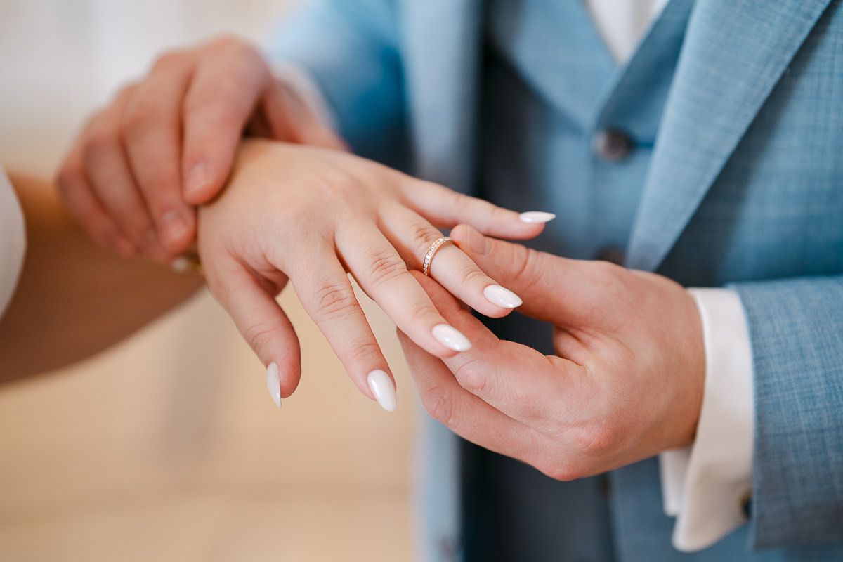 Close-up of ring exchange during civil ceremony.