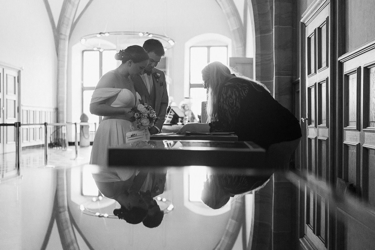 Editorial portrait with reflection in Aachen Rathaus Red Room.