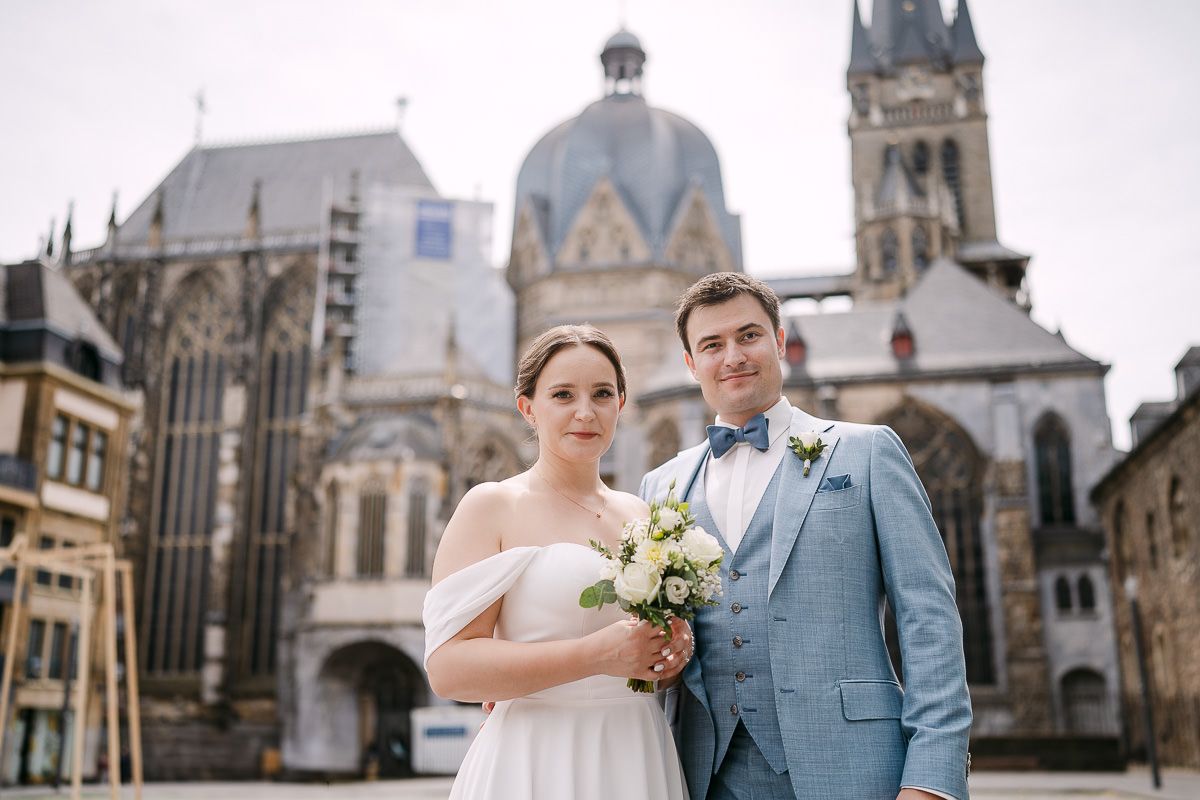Couple portrait with Aachen Cathedral skyline in background.