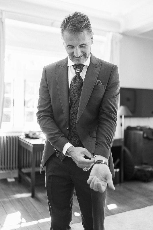 Groom portrait while getting ready inside Manoir de Lébioles