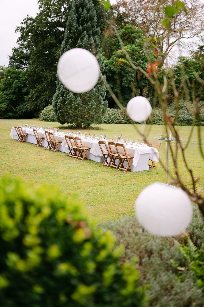White paper lanterns hanging above the outdoor dining area at Kasteel Aerwinkel.