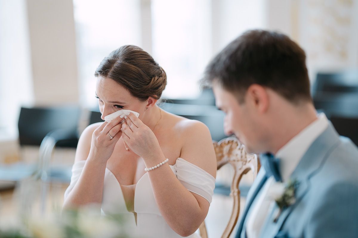 Bride wiping a tear during vows in White Hall.