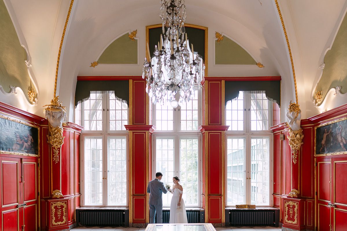 Wide editorial frame with chandelier in the Red Room.