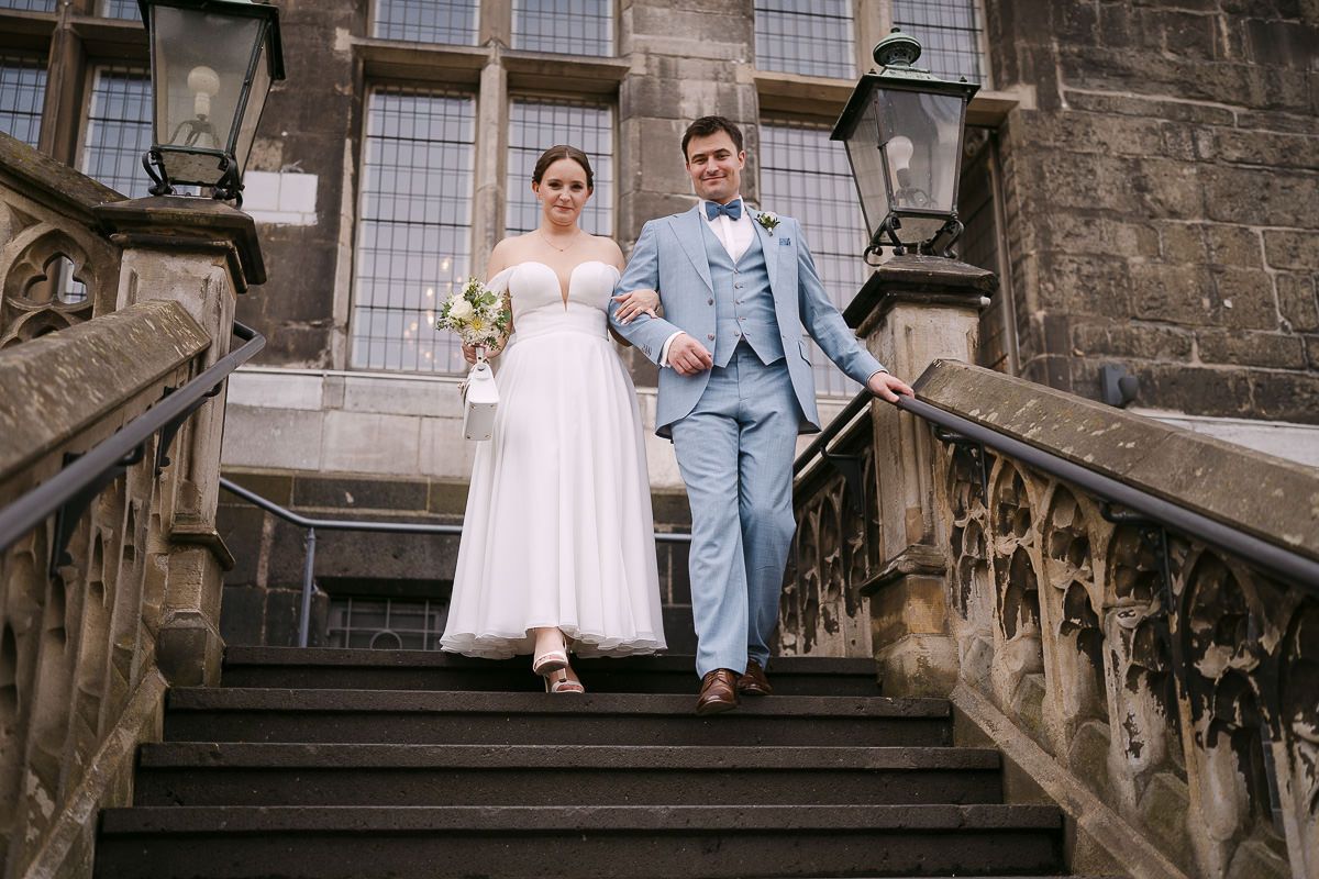Couple on exterior Rathaus stairs with Rathaus view.