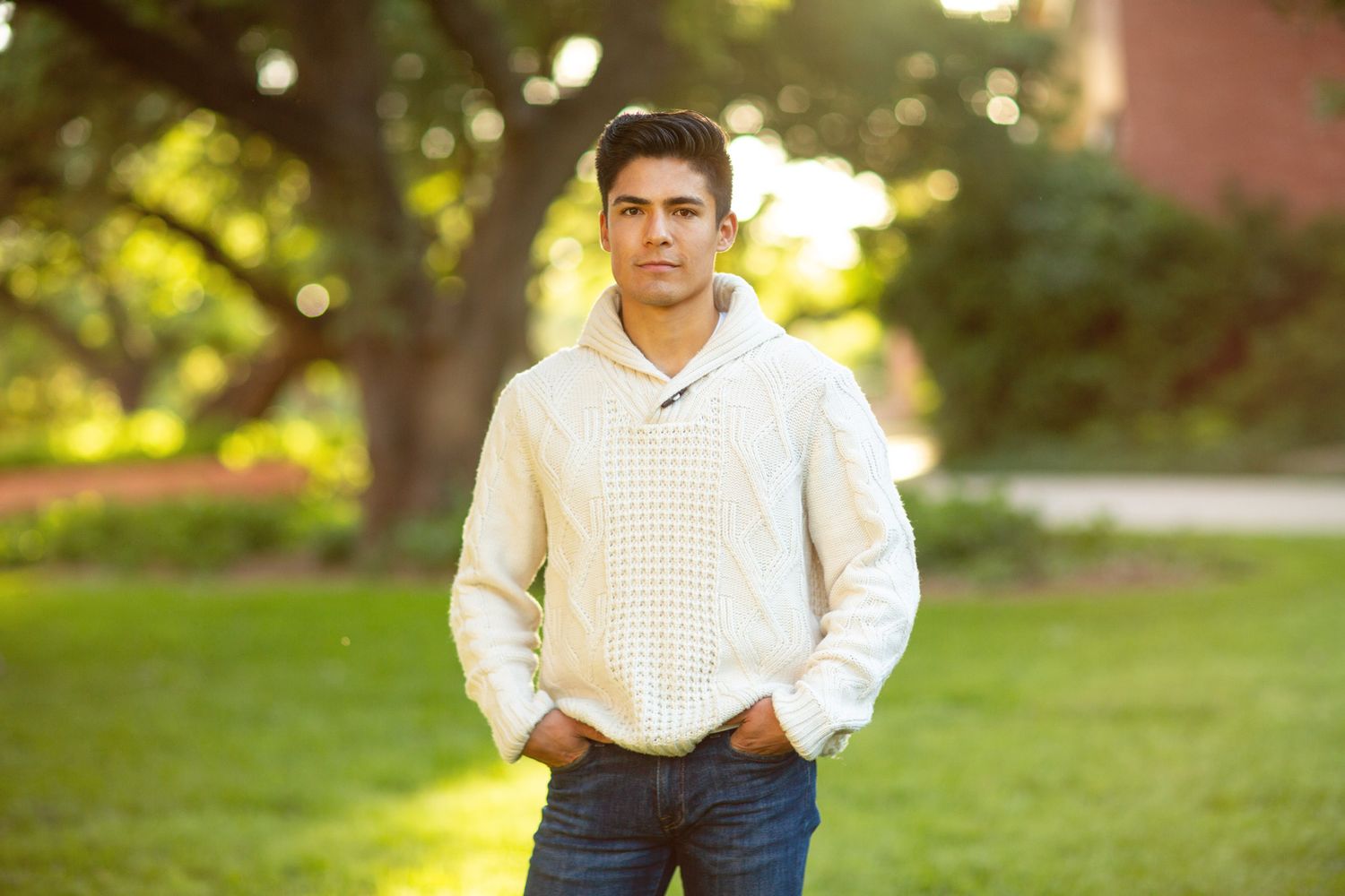 Person sitting outdoors in a collage of cropped photographs wearing casual attire against a natural sunlit background.