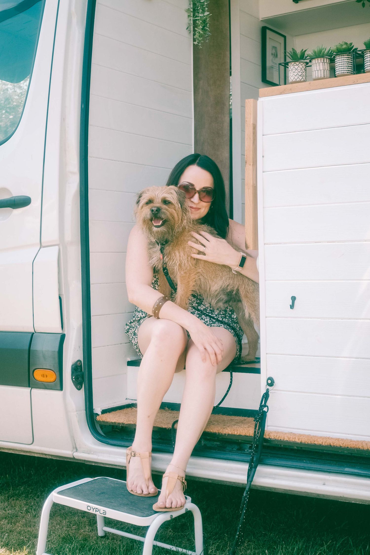 A dog is shown being held while lounging on a white porch in a series of four connected images.
