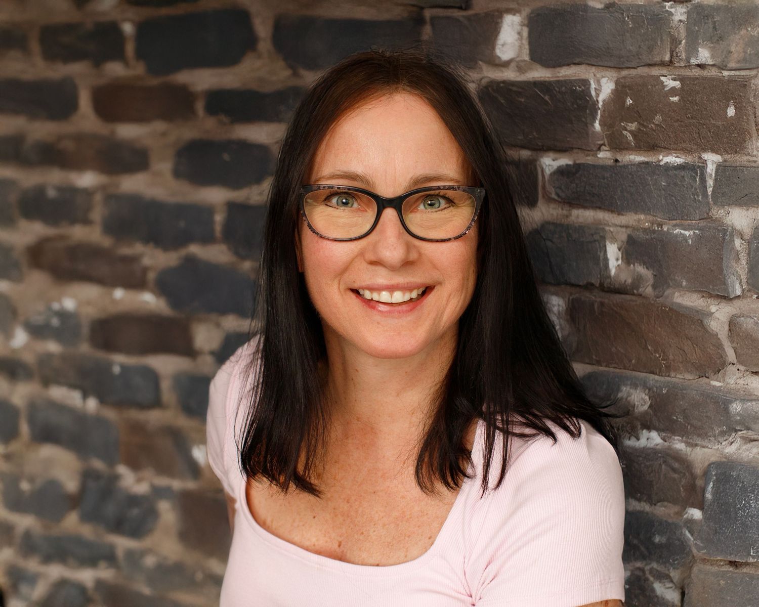 Bergen County Family Photographer, NJ Headshot Photographer, NJ Powder Sports Photographer - approachable headshot in front of wall