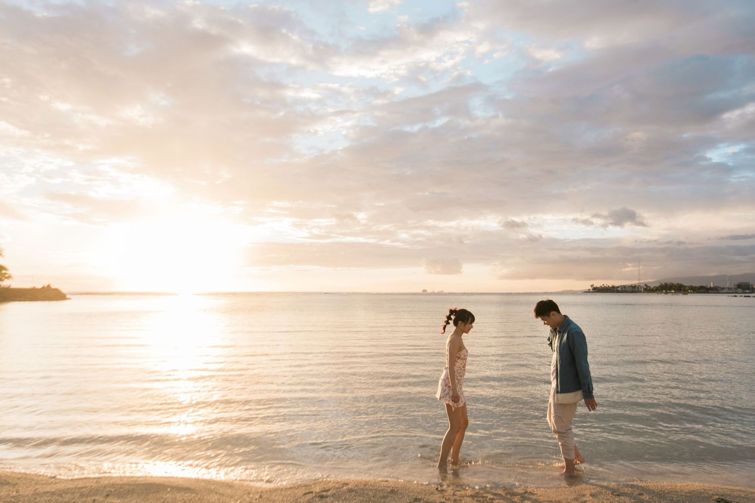 Couple walking along the beach at sunset in Hawaii