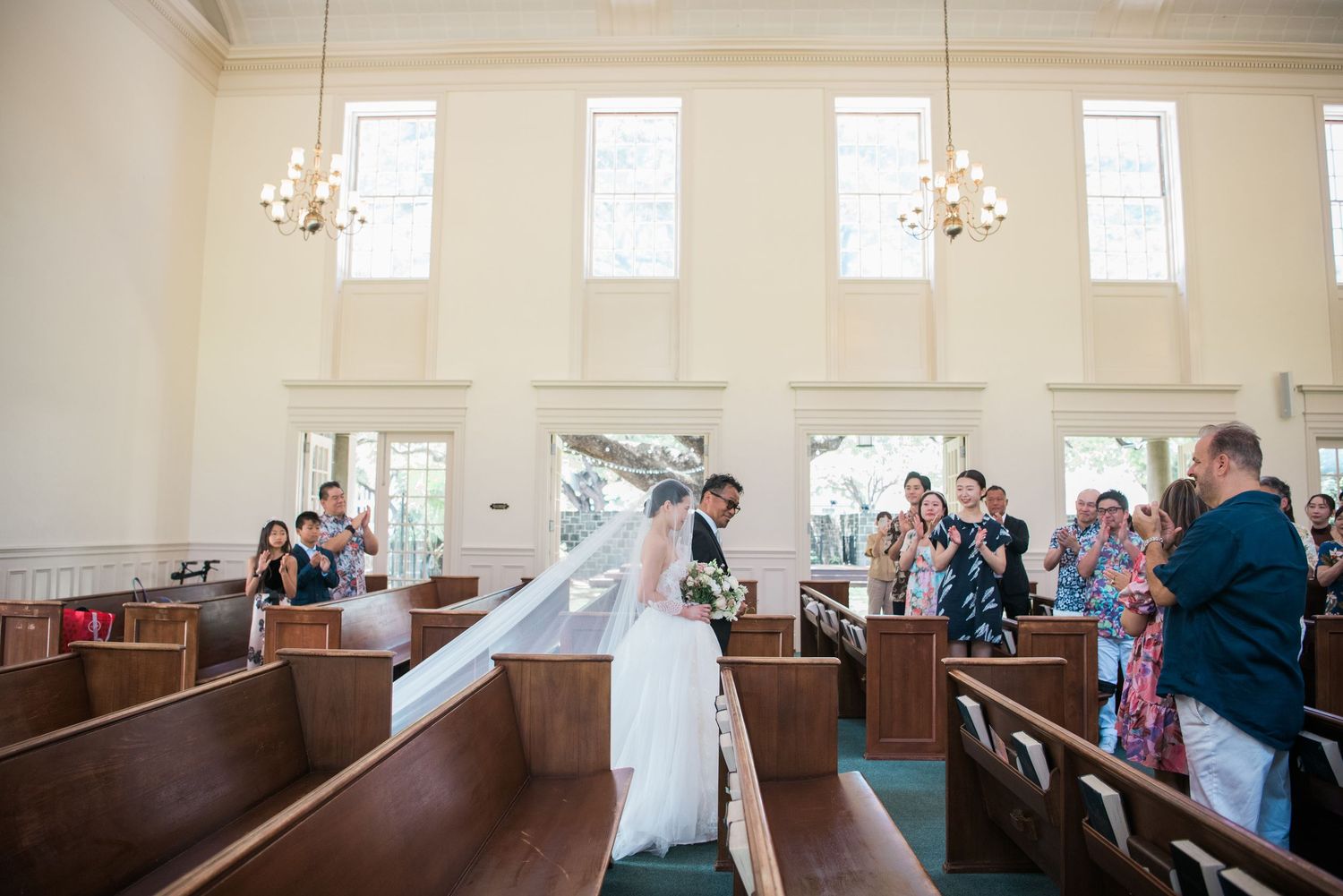 Bride walking down the aisle during a Hawaii wedding ceremony