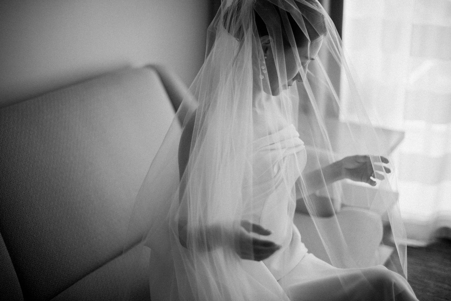 Black and white portrait of a bride in her veil during wedding preparations