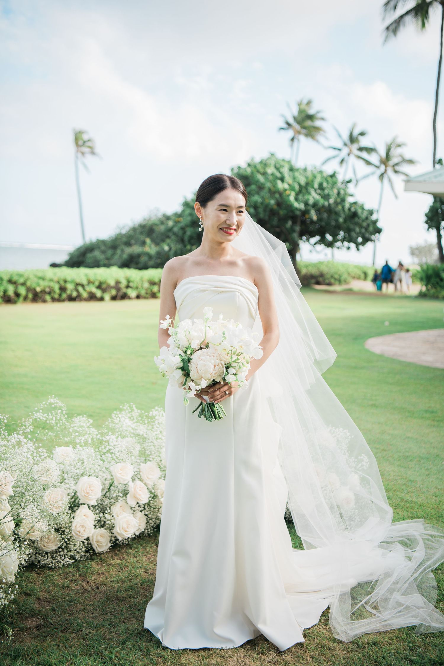 Bride holding her bouquet during an outdoor wedding in Hawaii