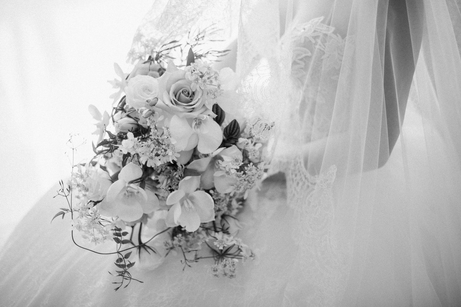 Black and white detail of a bride holding her wedding bouquet