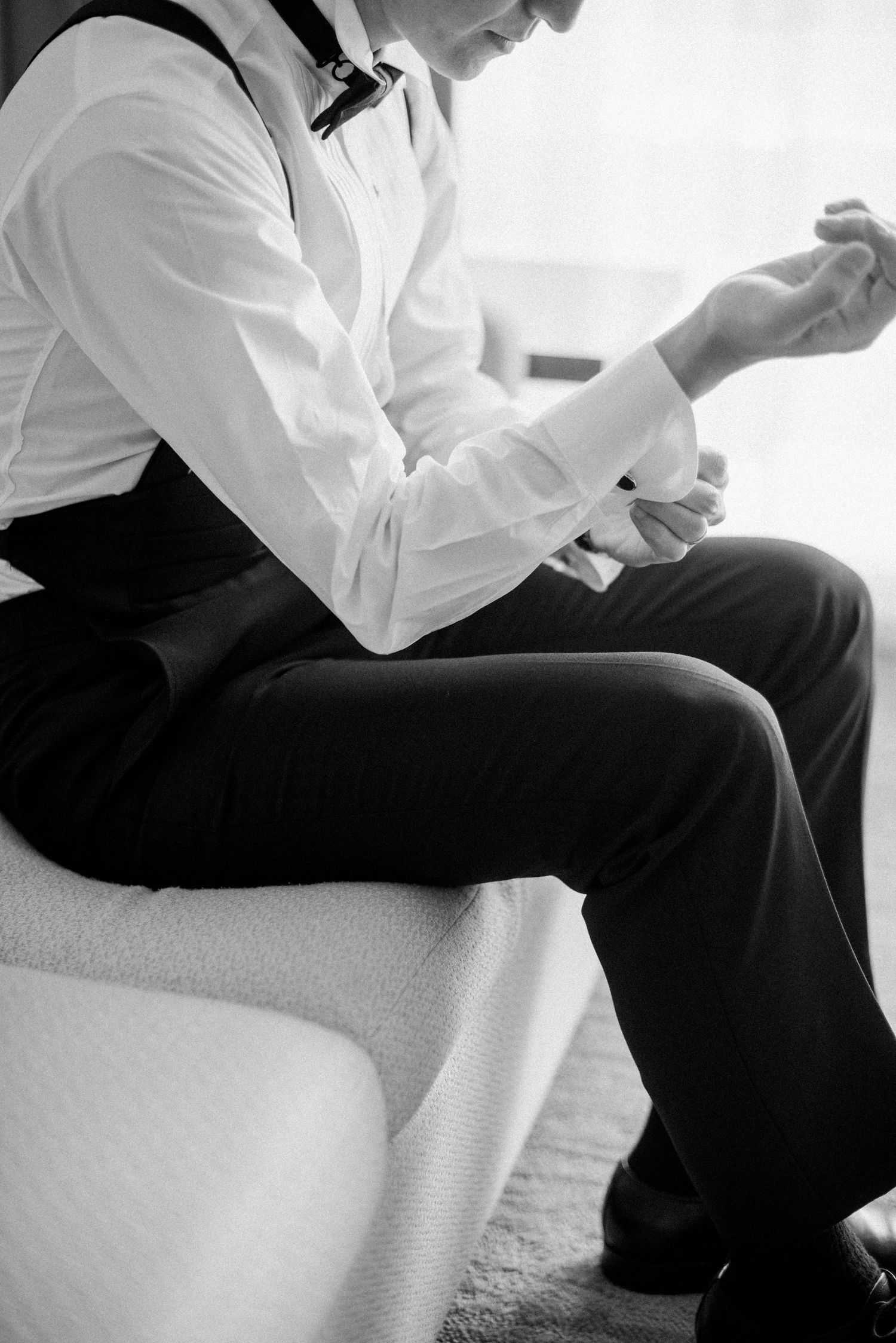 Groom getting ready before the wedding ceremony in black and white