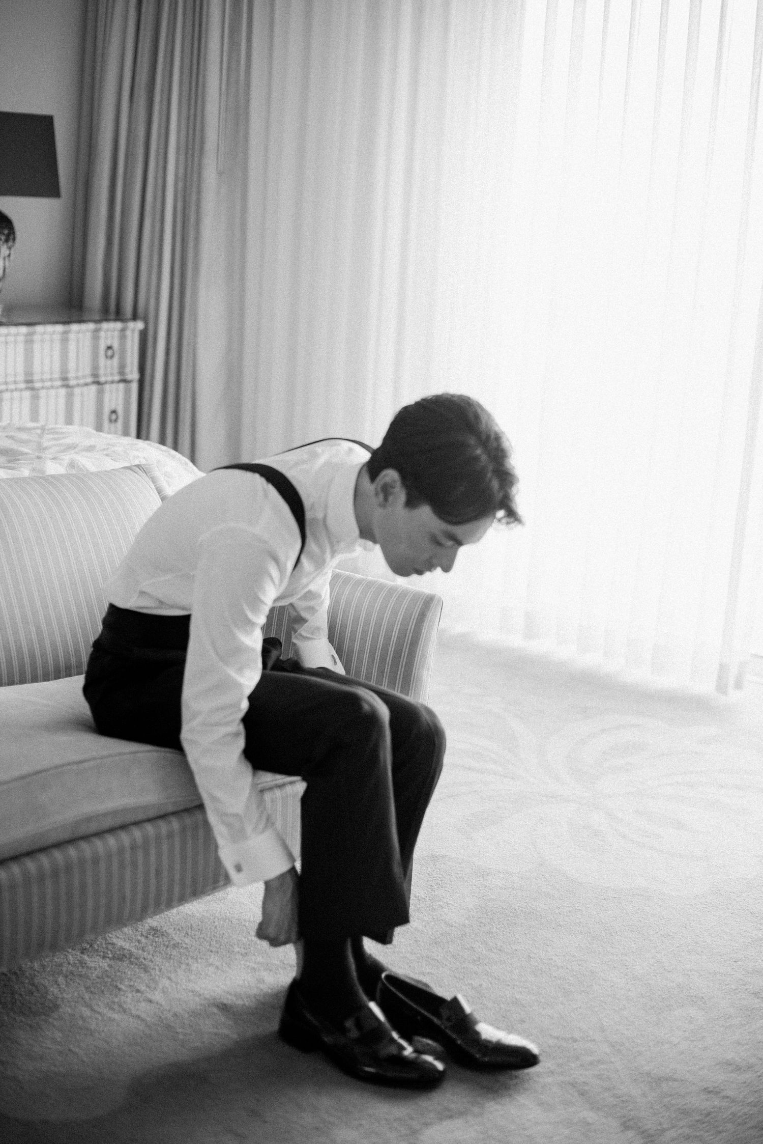 Groom getting ready before his wedding ceremony in black and white