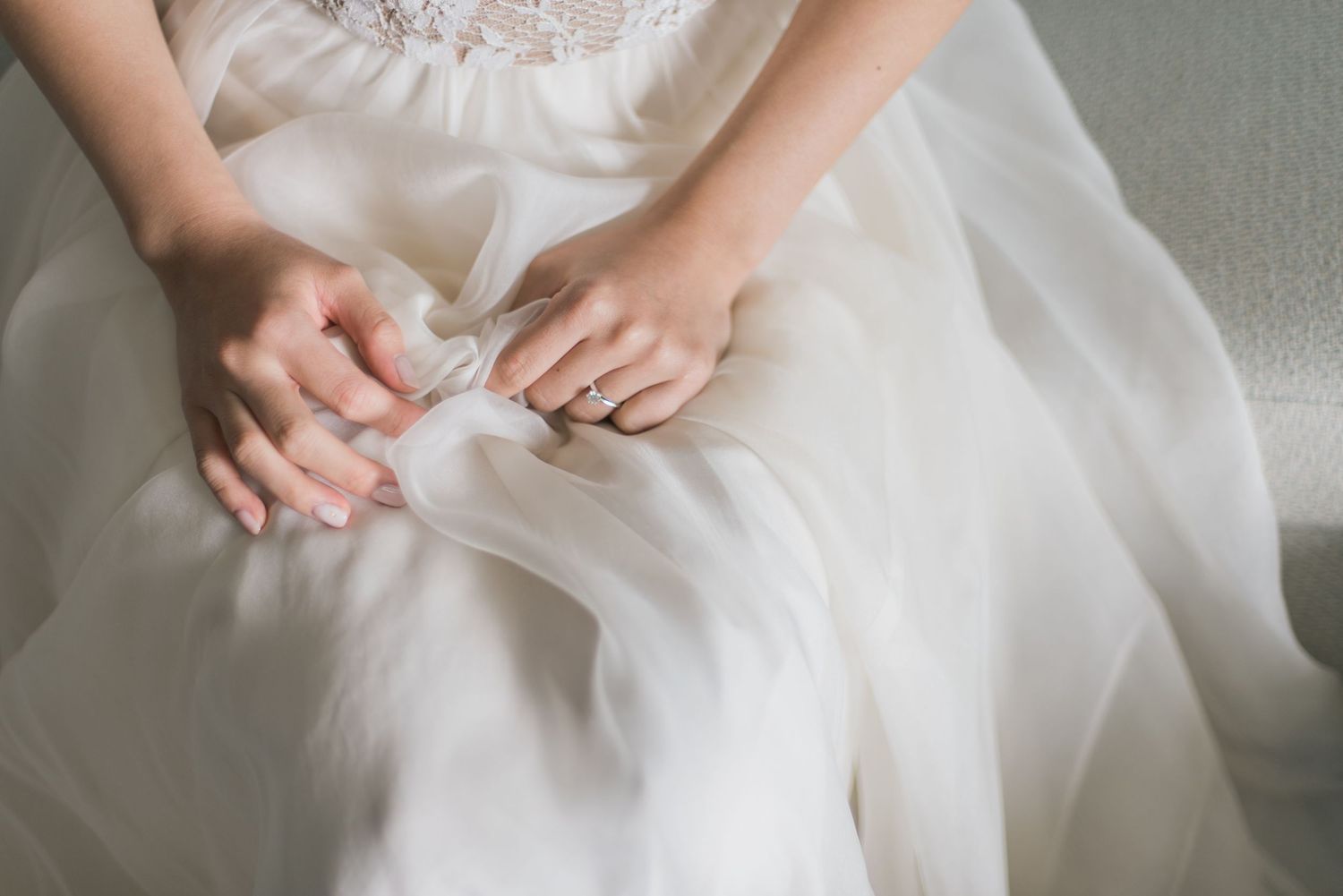 Close-up of a bride’s hands and wedding ring while getting ready