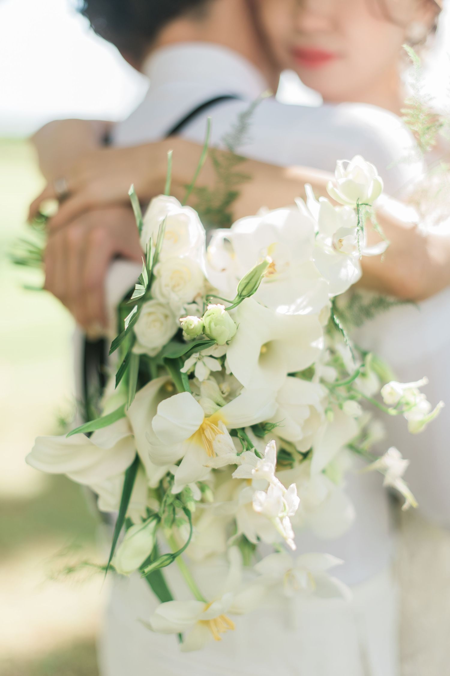 Close-up of a bride holding a cascading white wedding bouquet