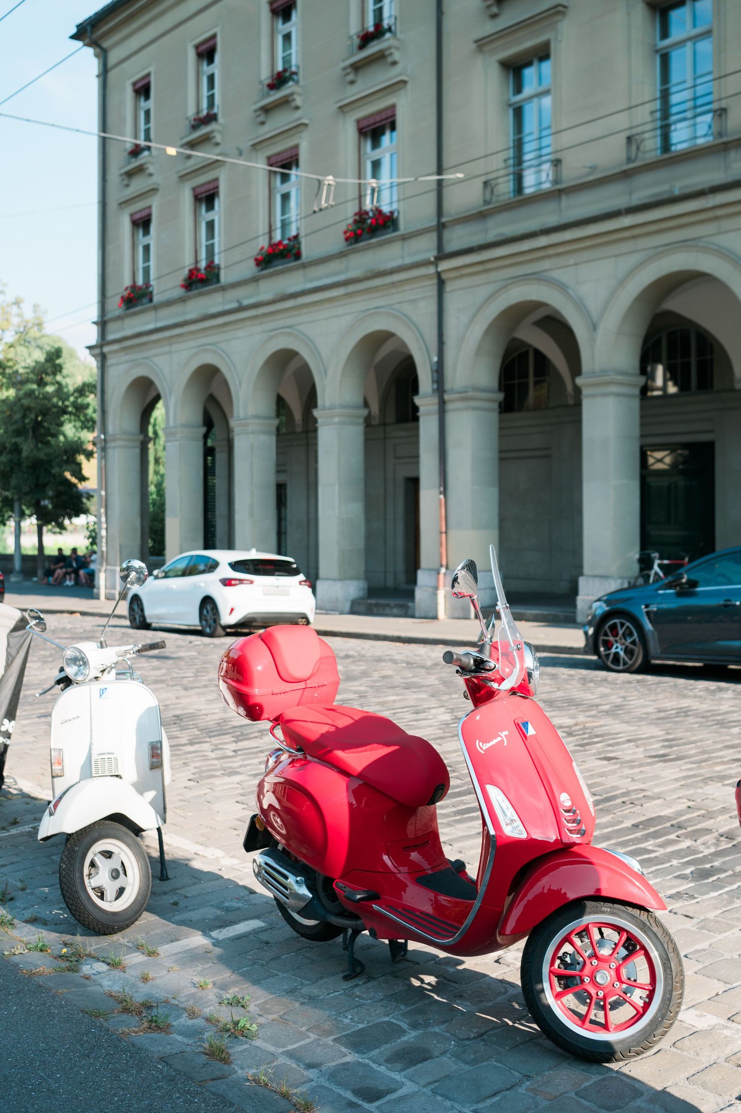 Red and white scooters parked on a European street