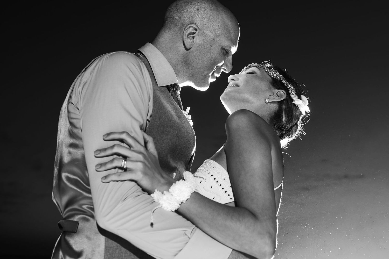 Black-and-white nighttime portrait of Juliana and Tom looking lovingly at each other.