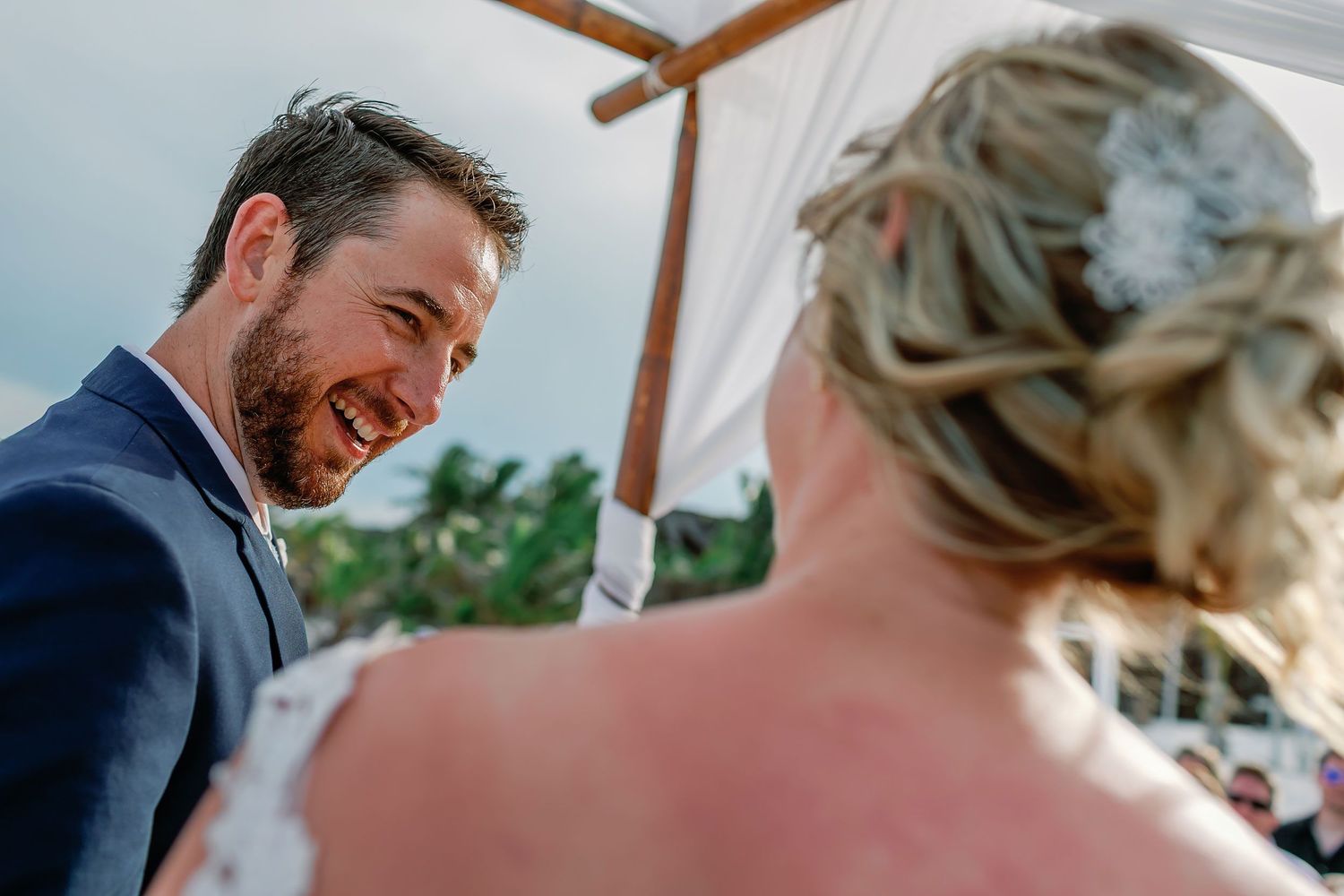 Matt laughs with Ashley during their sunlit ceremony at the Tulum beach club.