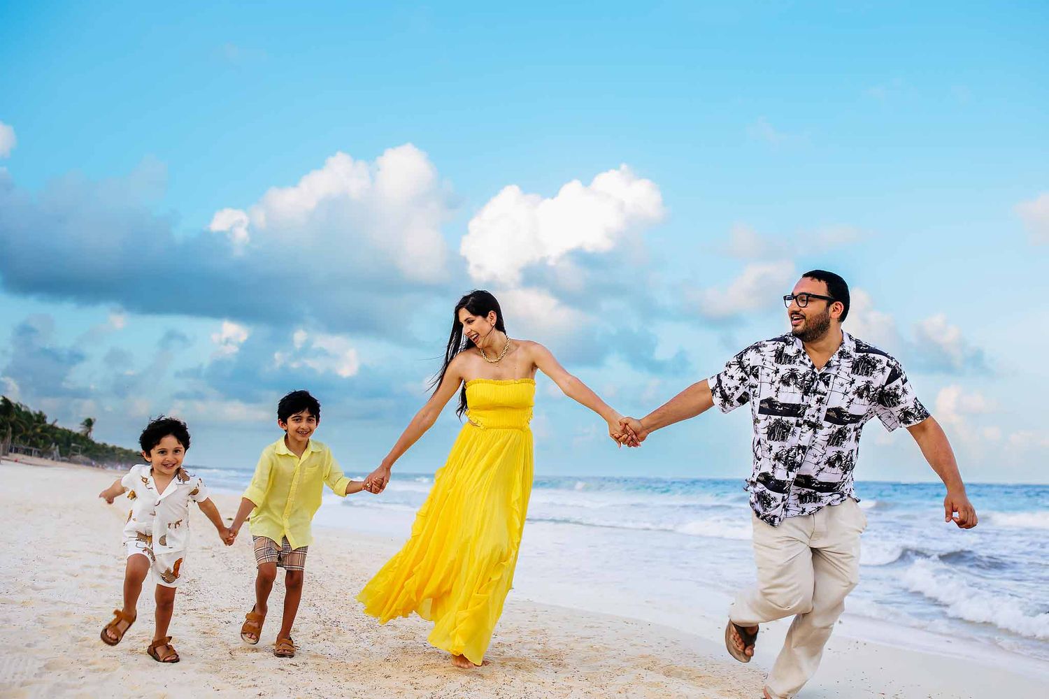 Family photoshoot in Cancun at sunset with candid beach moments