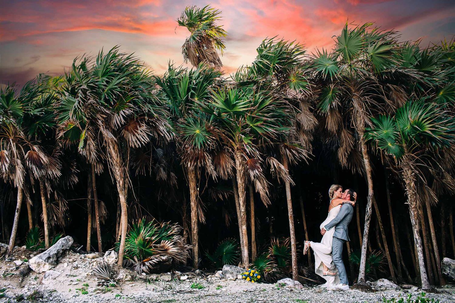 Bride and groom embracing in tropical jungle at sunset in Playa del Carmen, destination wedding photography Riviera Maya