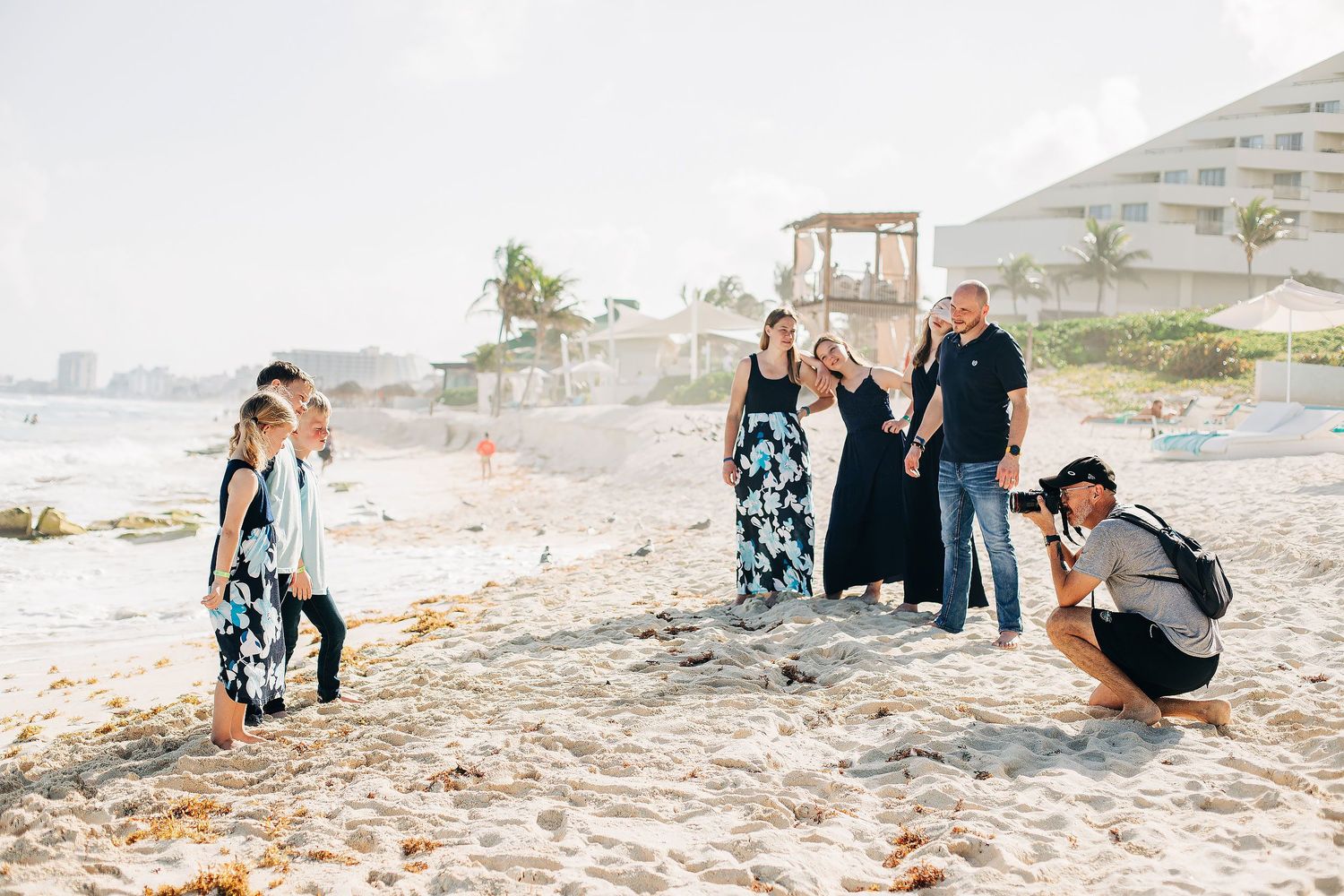 Ivan Luckie photographing a family session on the beach in Cancun, Mexico with Luckie Photography.